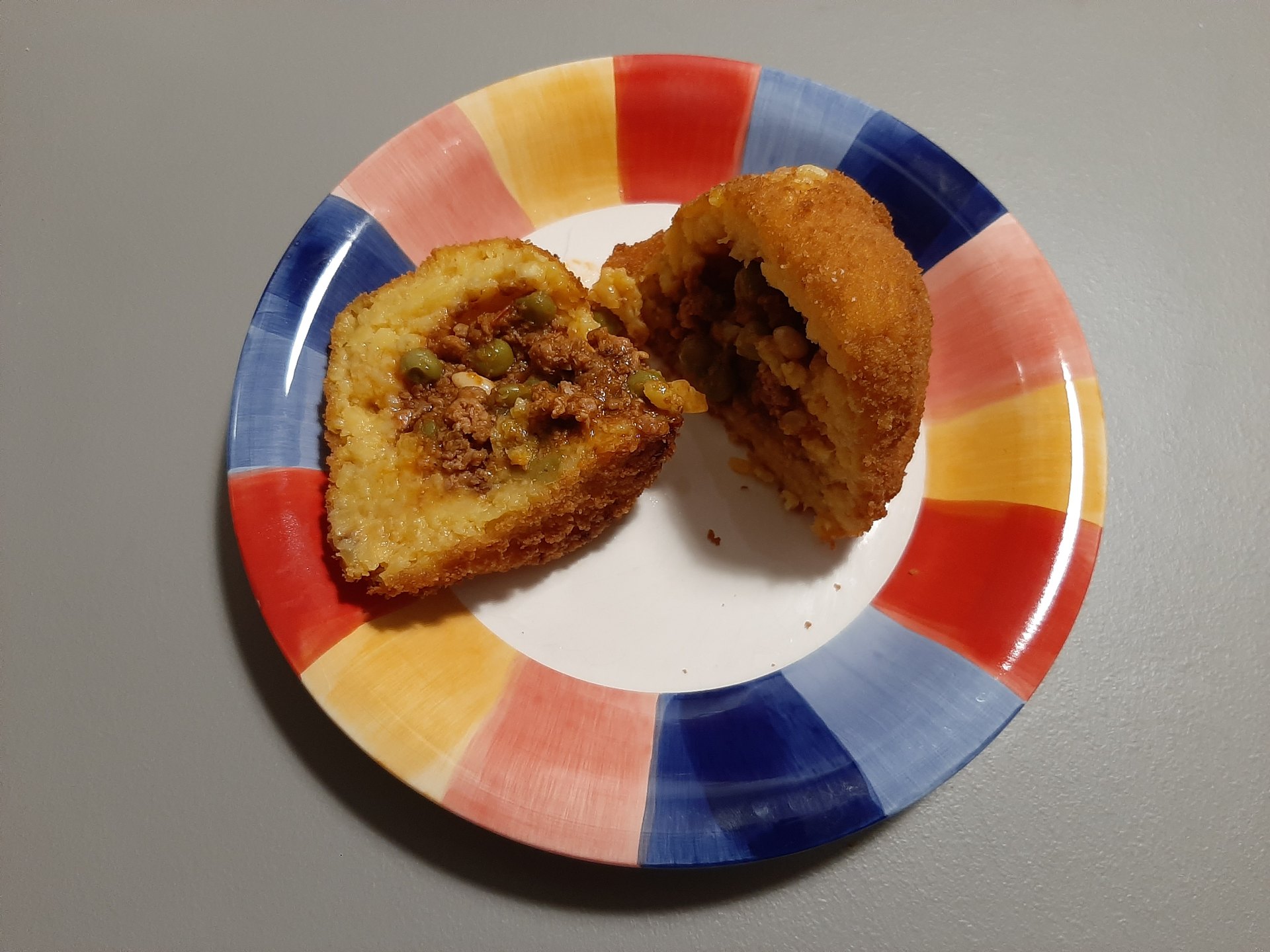 Meat-filled arancina from Alcamo cut open to show its filling