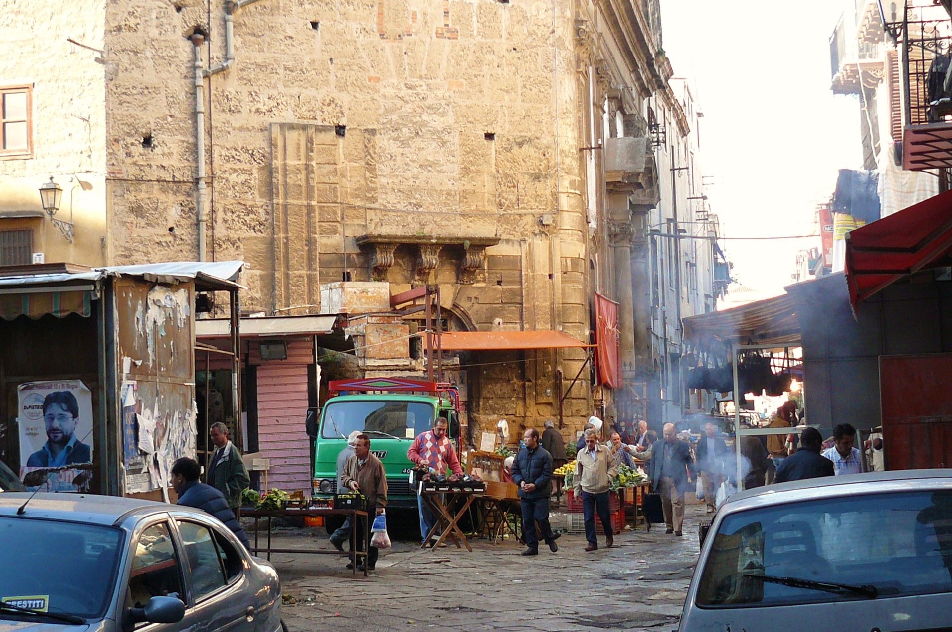 A lively street around a Palermo food market