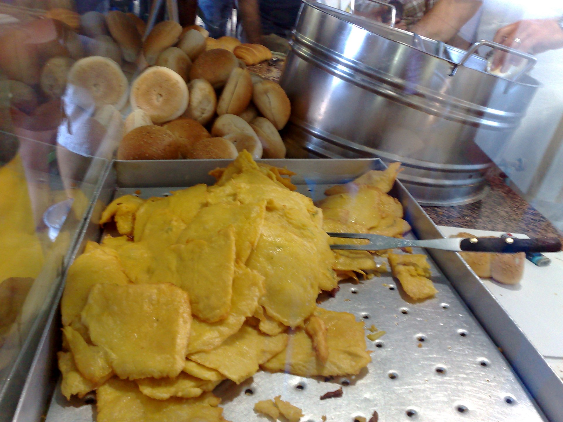 Freshly fried panelle displayed on a Palermo counter